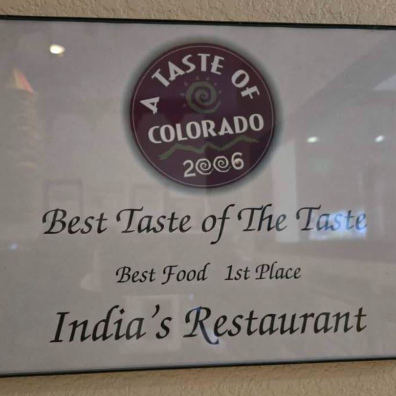 A framed award certificate for "Best Taste of The Taste, Best Food 1st Place" for India's Restaurant.