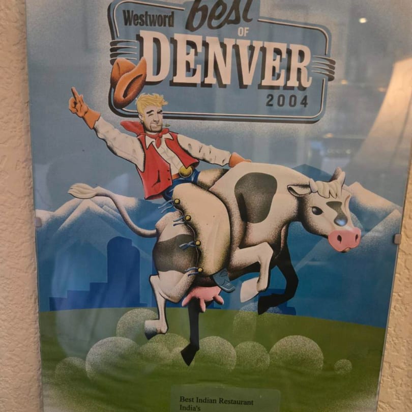 Cartoon cowboy riding a cow, with "Westword Best of Denver 2004" and "Best Indian Restaurant India's" text.
