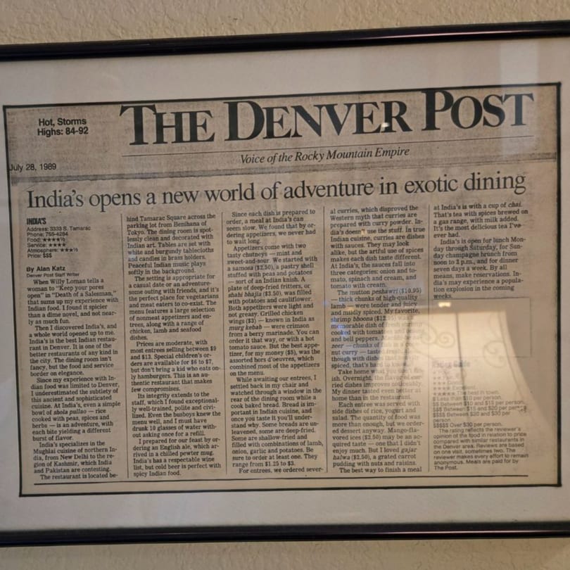 A framed newspaper clipping from The Denver Post, dated July 28, 1989, reviewing INDIA'S Restaurant.