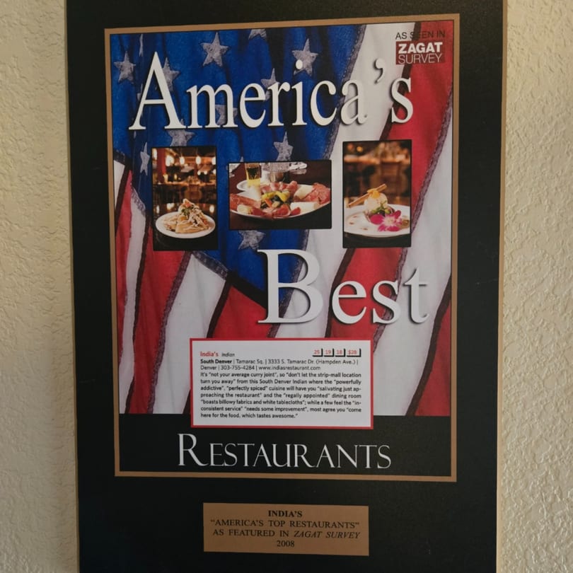 A framed Zagat Survey plaque for INDIA'S Restaurant, featuring food photos and reviews.